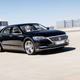 A photo of a black VW Phaeton D2 concept car driving in an airport.